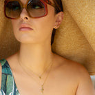 model wearing Gold Palm Tree studs