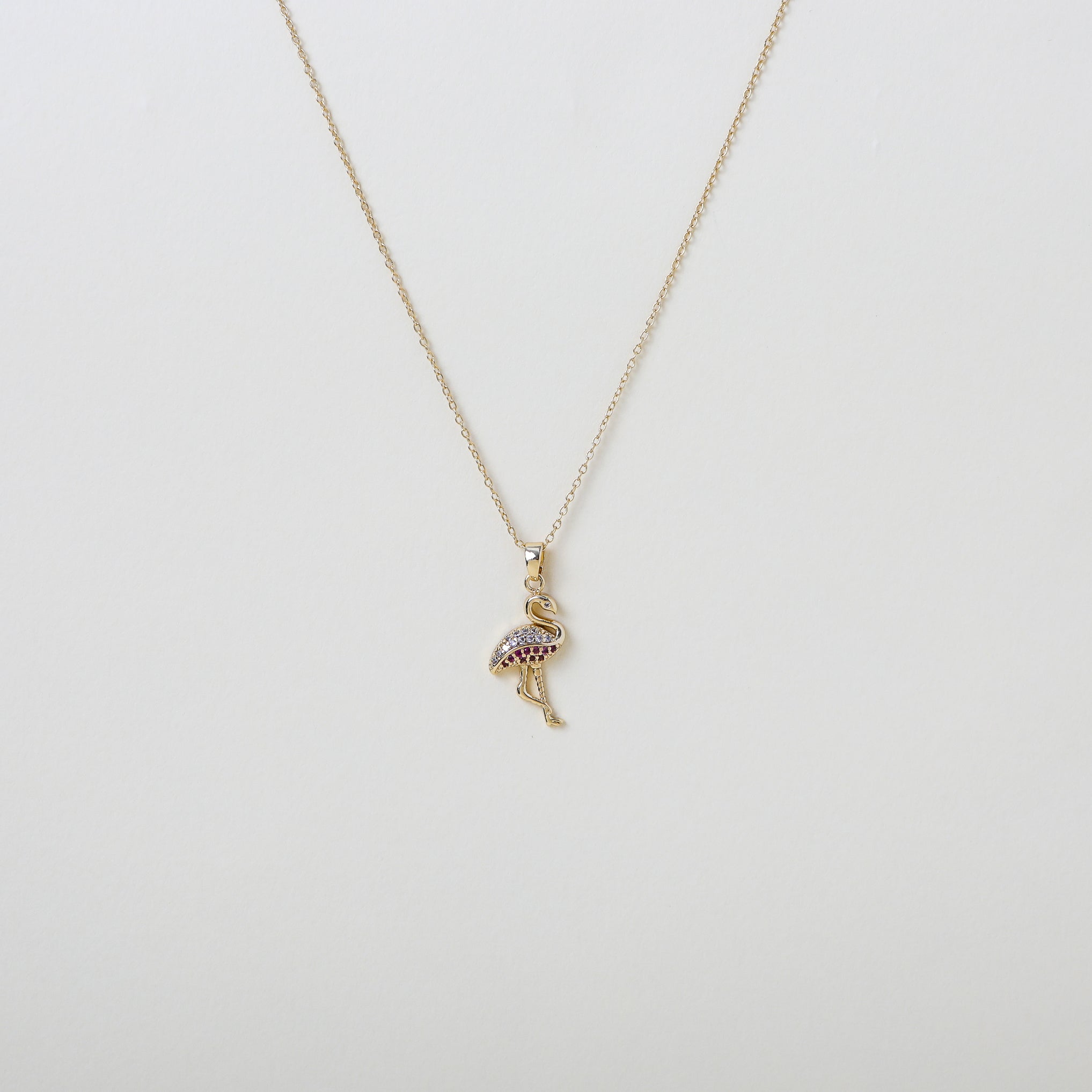 Gold chain with pink  and white crystal accented flamingo pendant