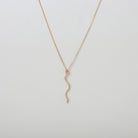 Gold necklace with a gold & crystal accented serpent