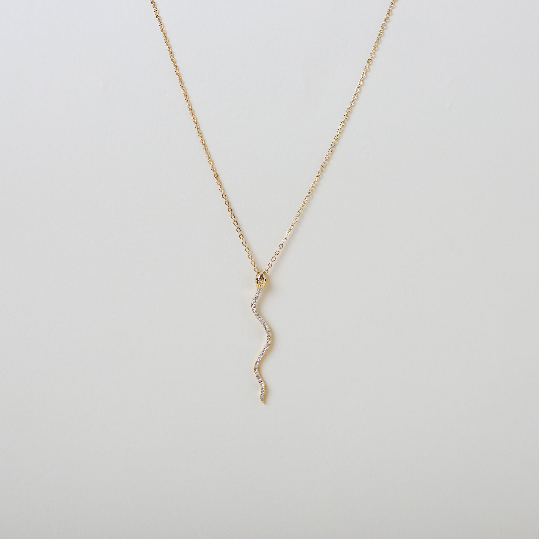 Gold necklace with a gold & crystal accented serpent