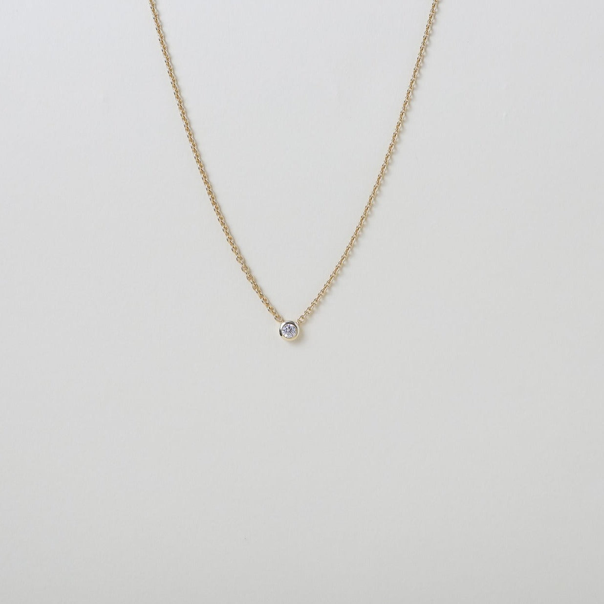 delicate Gold chain with a single crystal pendant