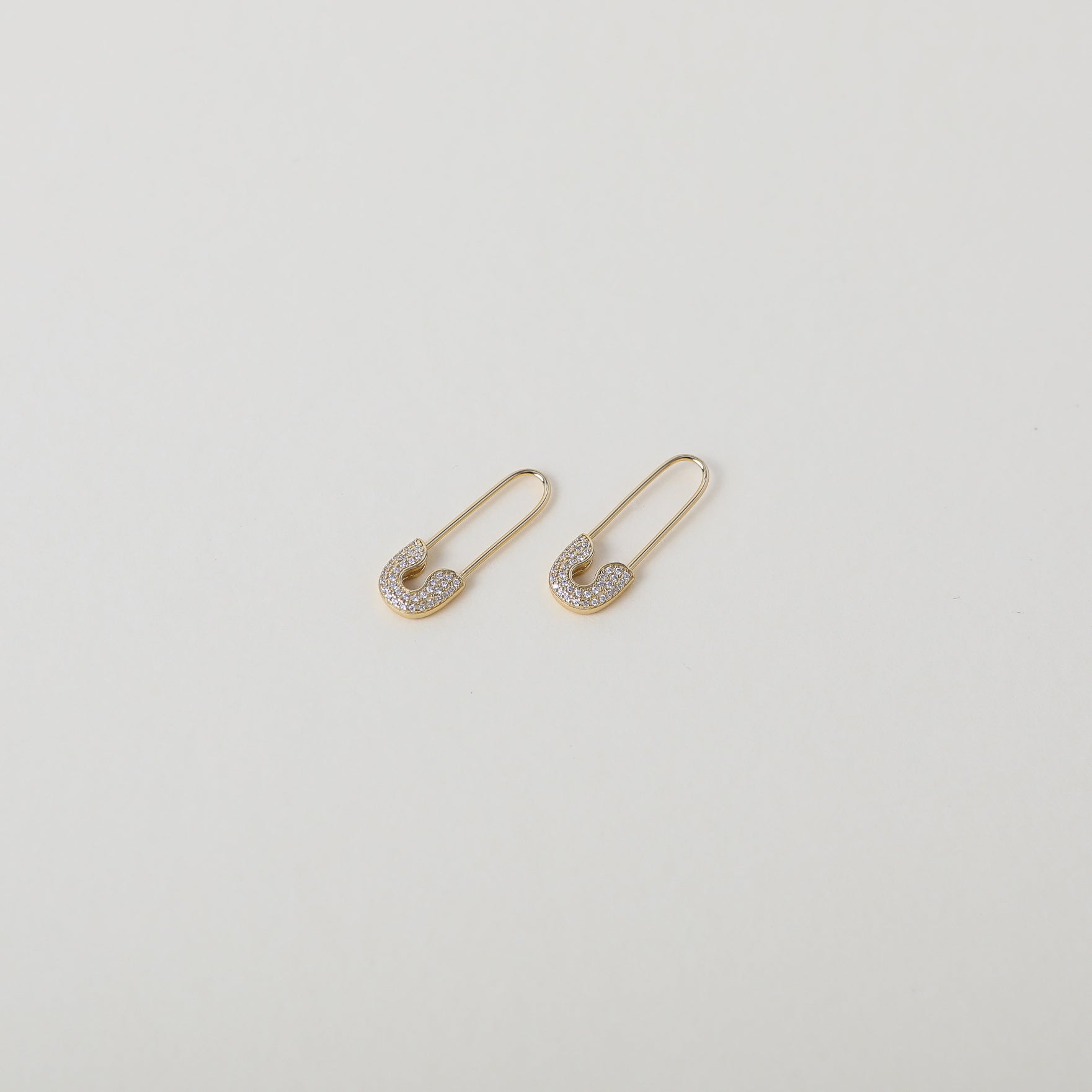 crystal accented gold safety pin earrings