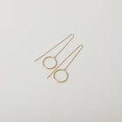 Gold thread through chain earrings featuring small hoop detail