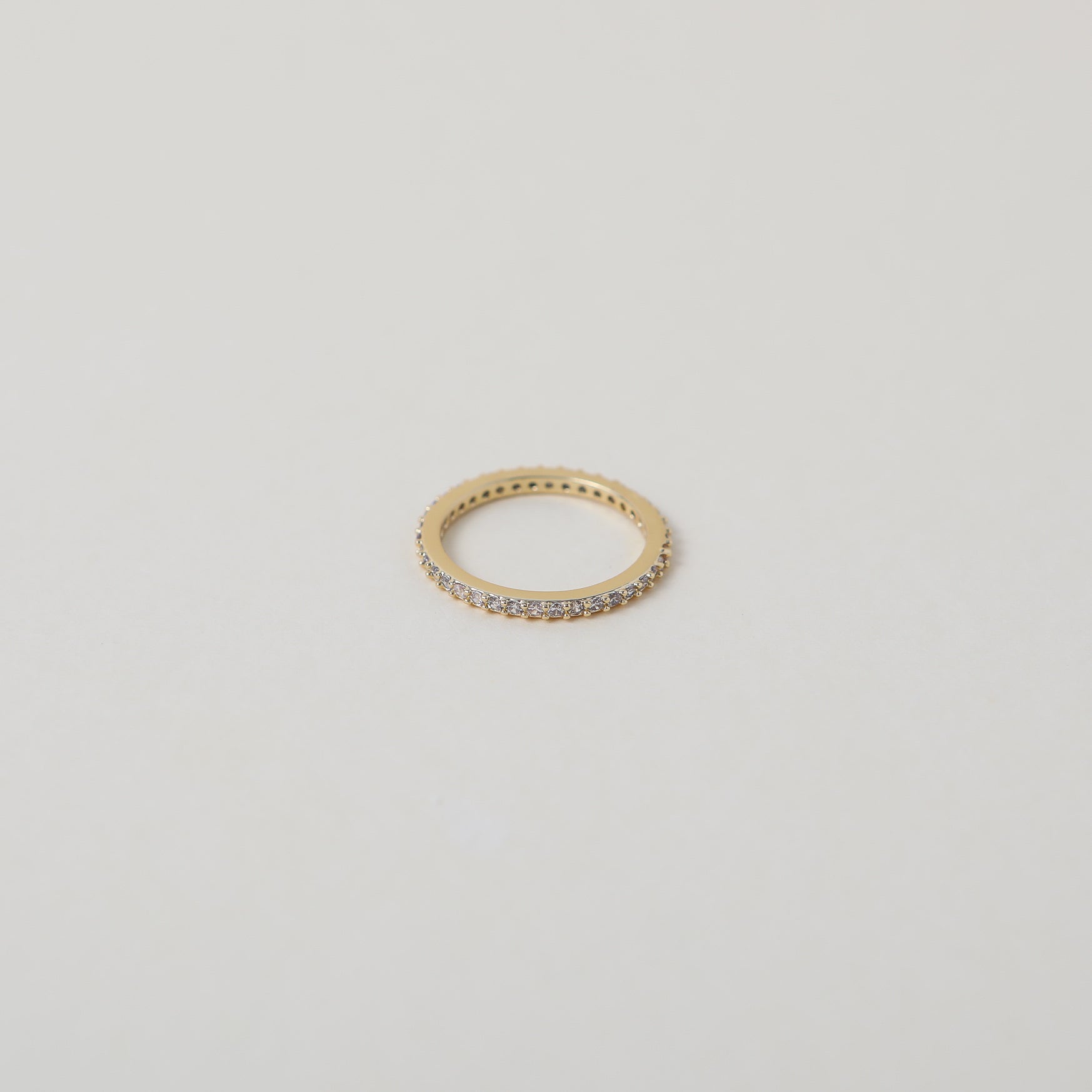 Crystal accented gold eternity ring
