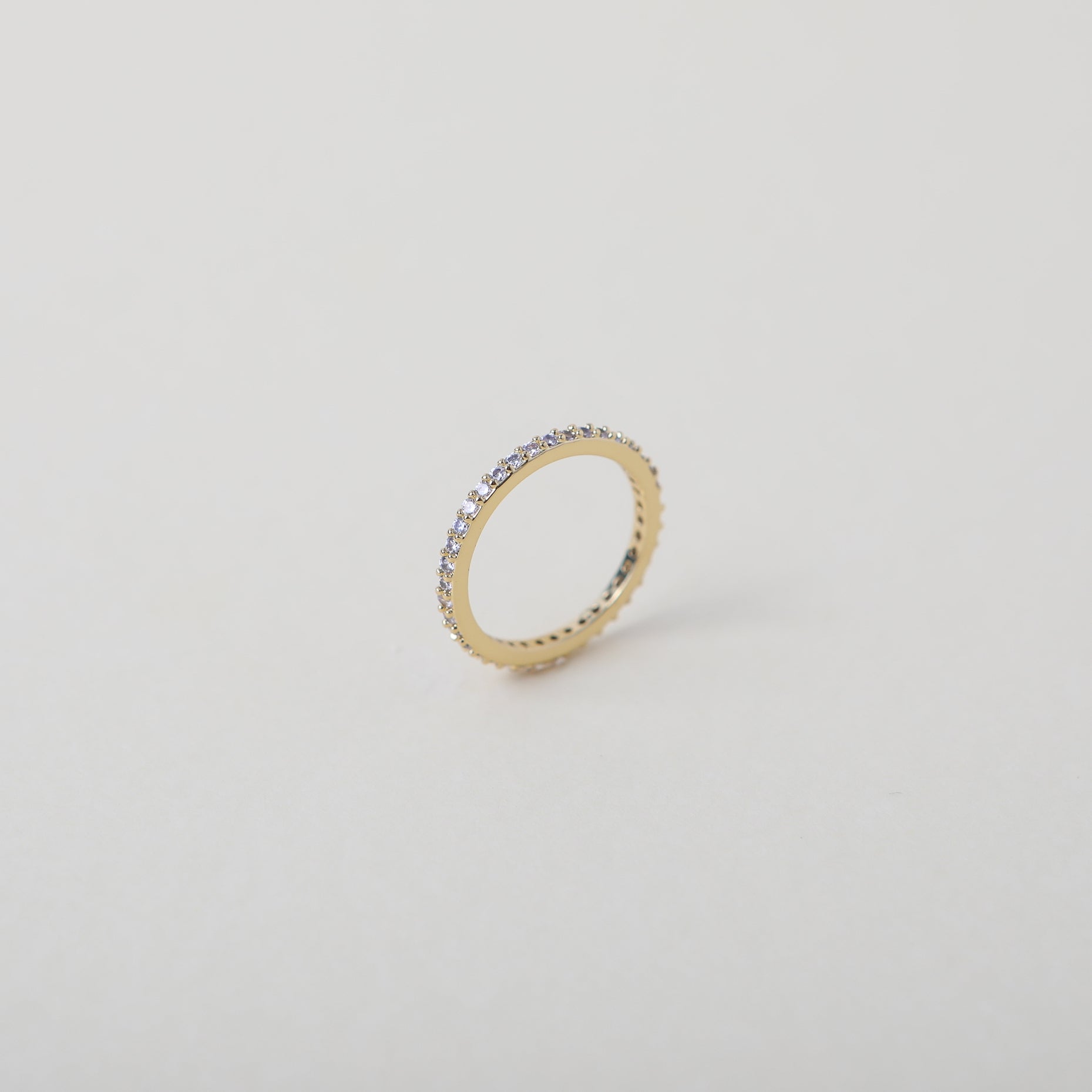 Crystal accented gold eternity ring