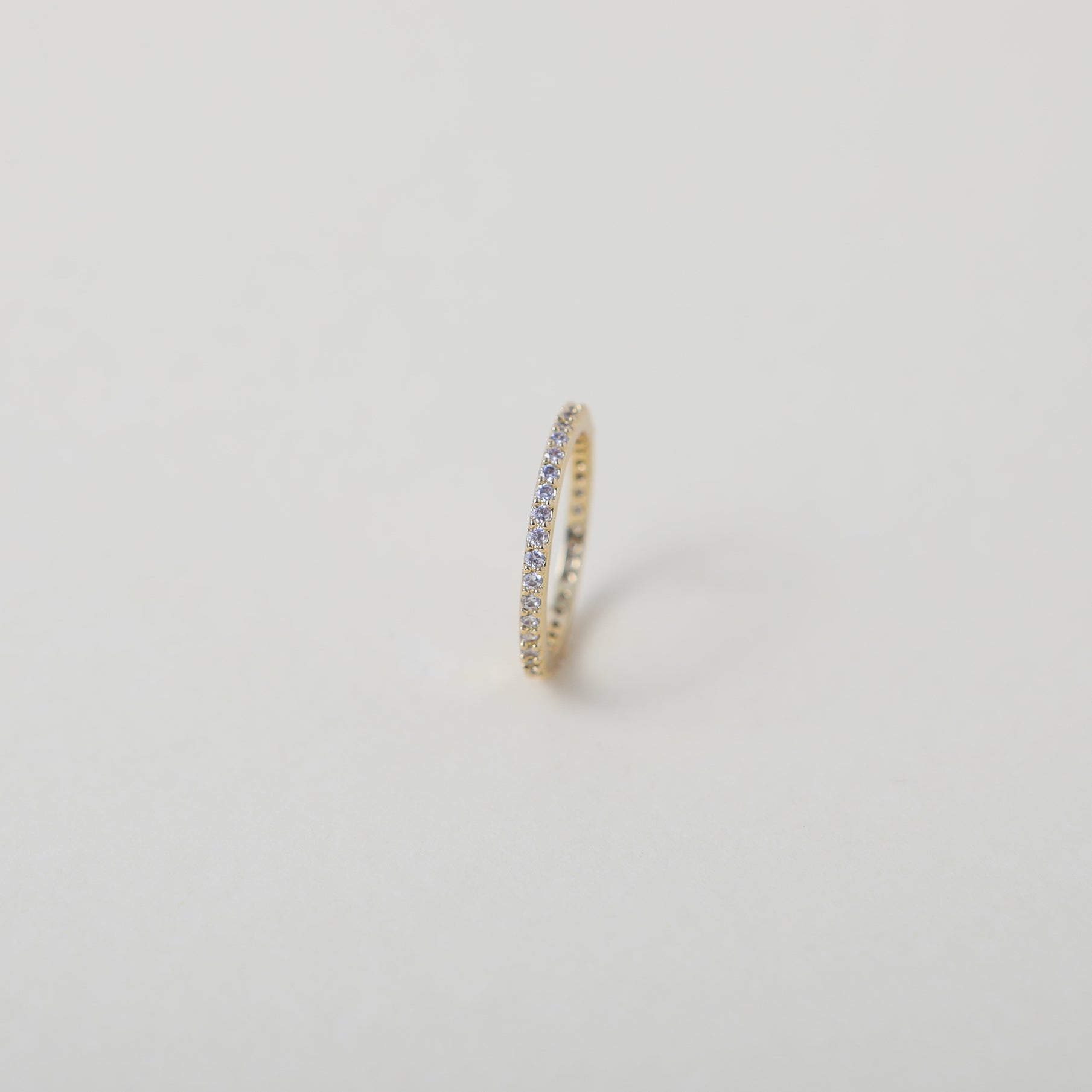 Crystal accented gold eternity ring