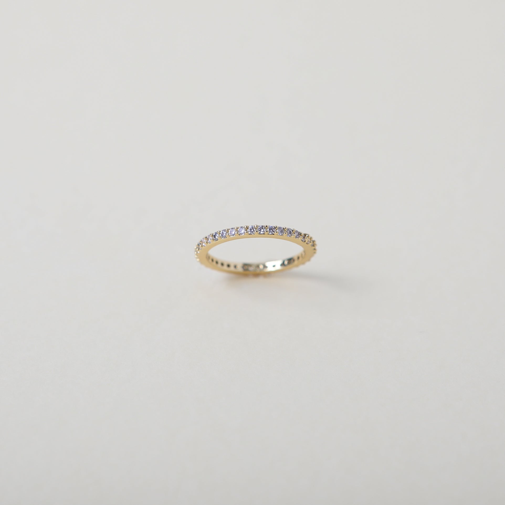 Crystal accented gold eternity ring