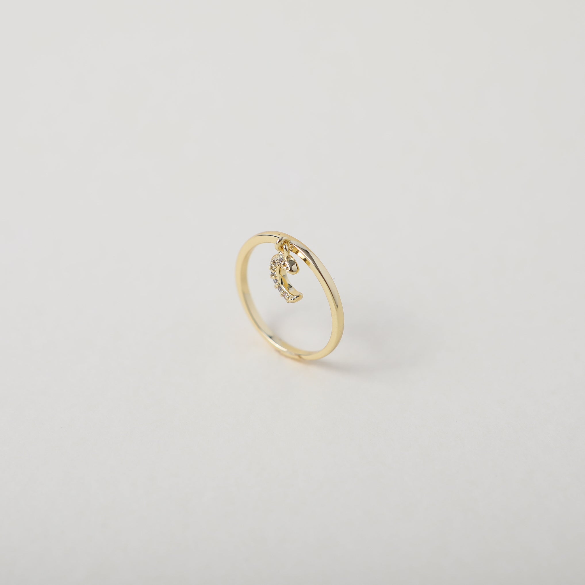 Delicate gold ring with crystal accented crescent moon charm