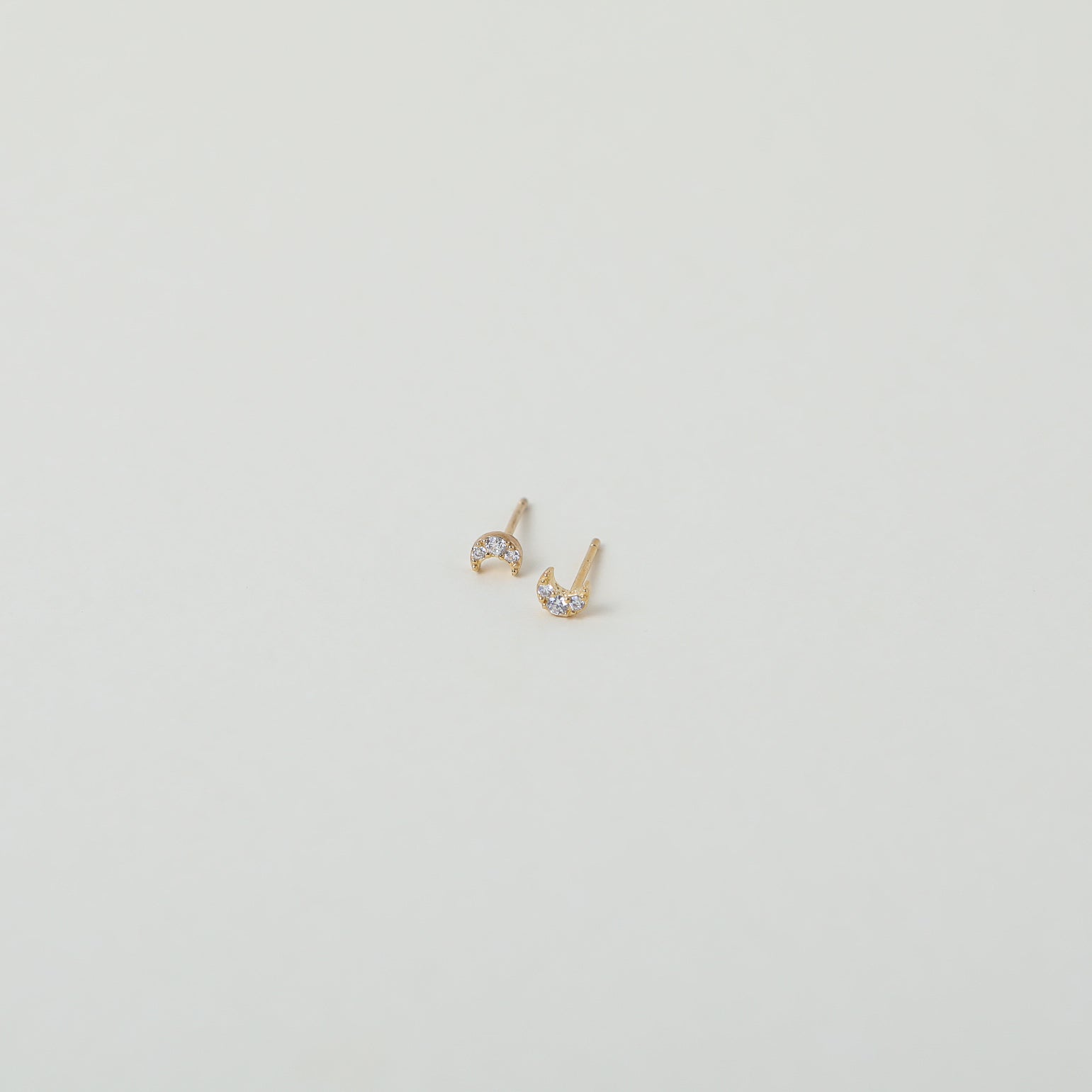 Micro gold moon studs with crystal accents