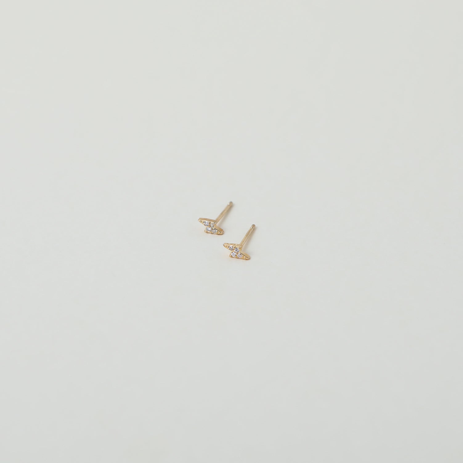 Micro gold lightening bolt studs with crystal accents