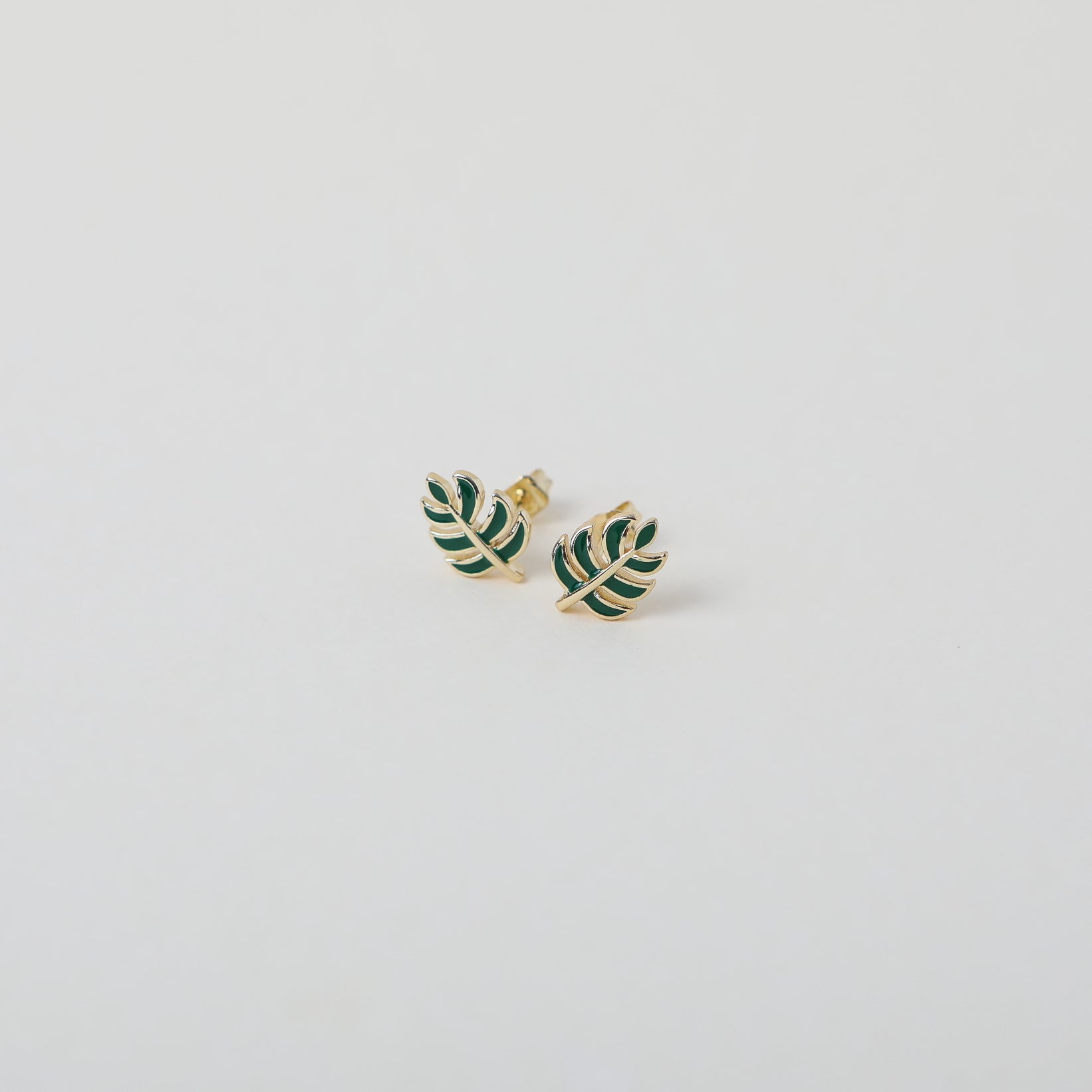 gold and green enamel leaf studs