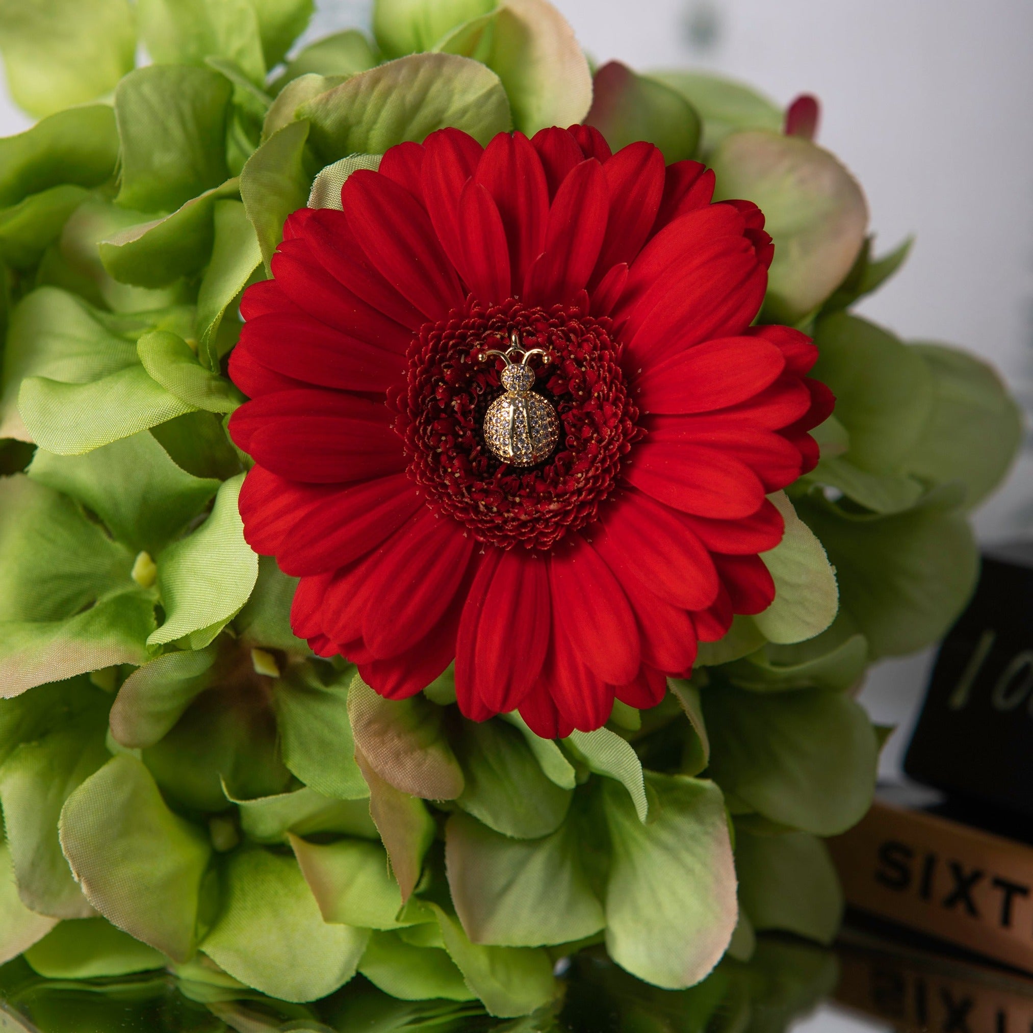 Crystal embellished Ladybird Charm sitting inside a bright red flower