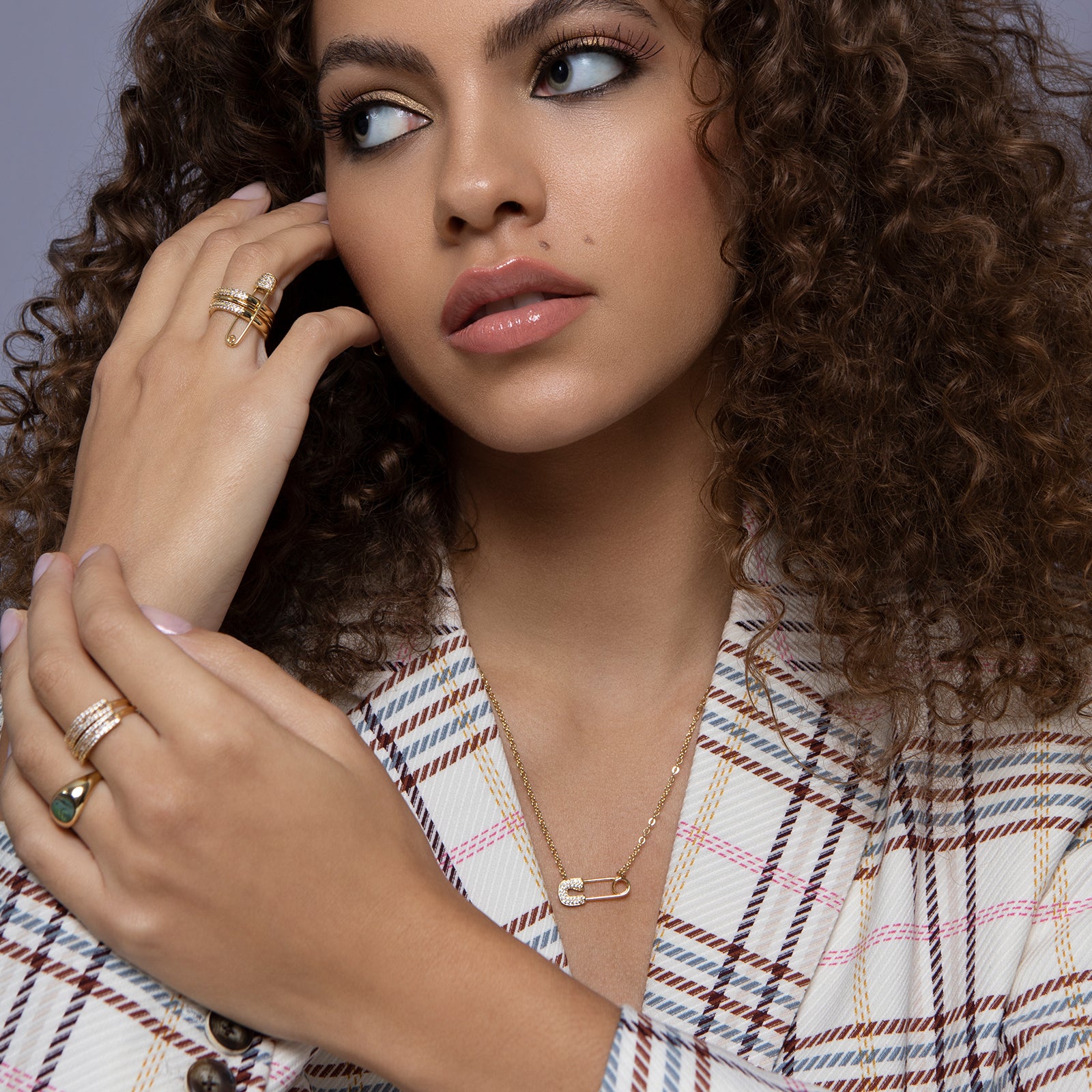 Gold safety pin accented with crystals on a gold chain