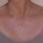 Gold necklace with a gold & crystal accented serpent