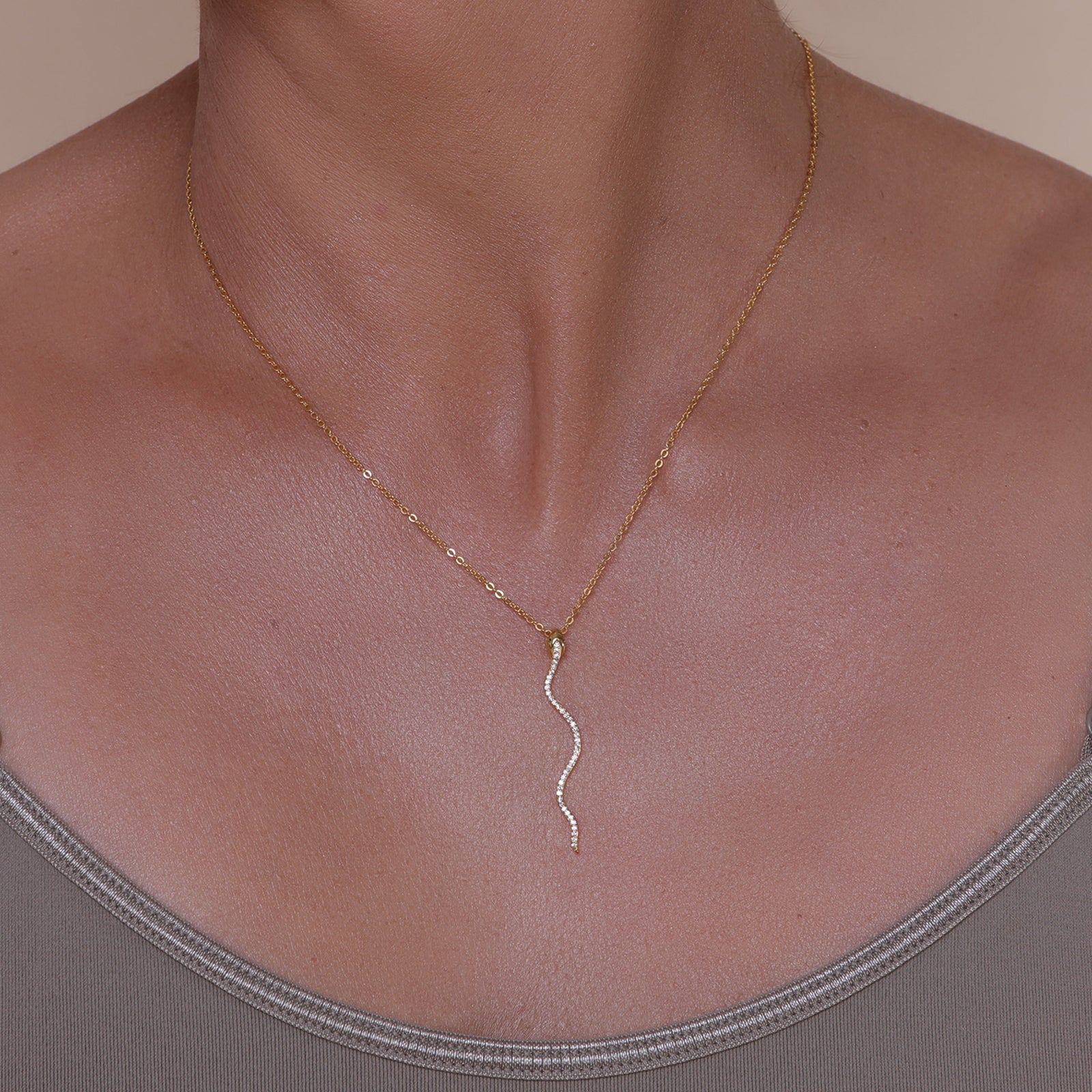 Gold necklace with a gold & crystal accented serpent