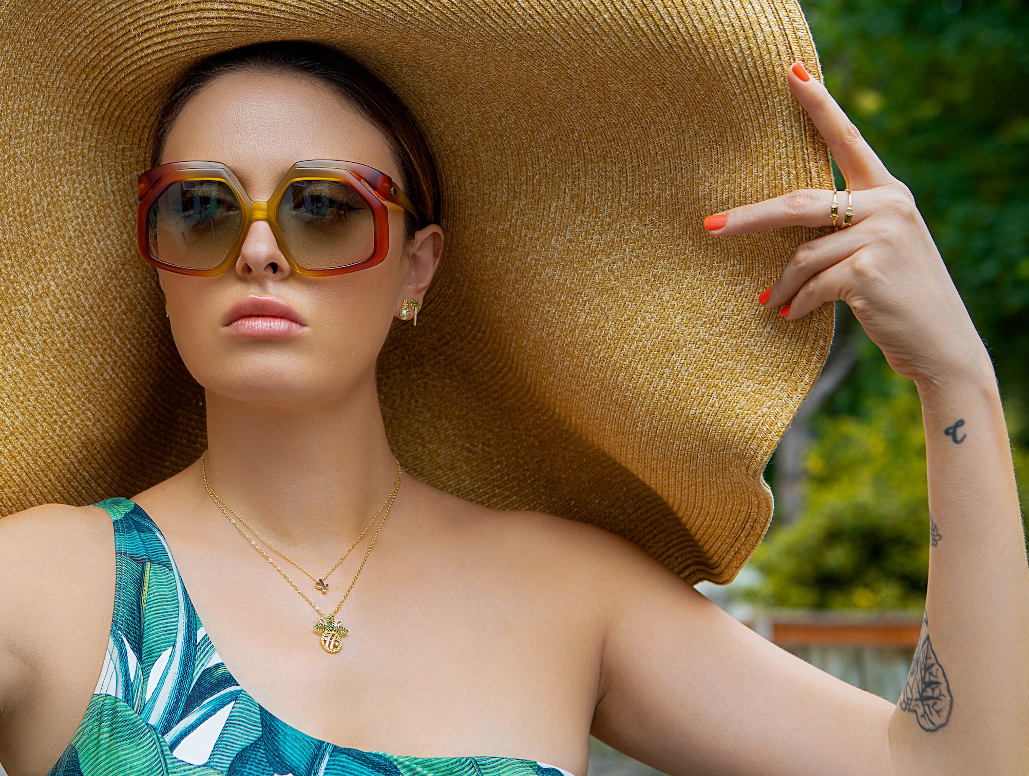 model wears peridot coloured crystal and gold ring