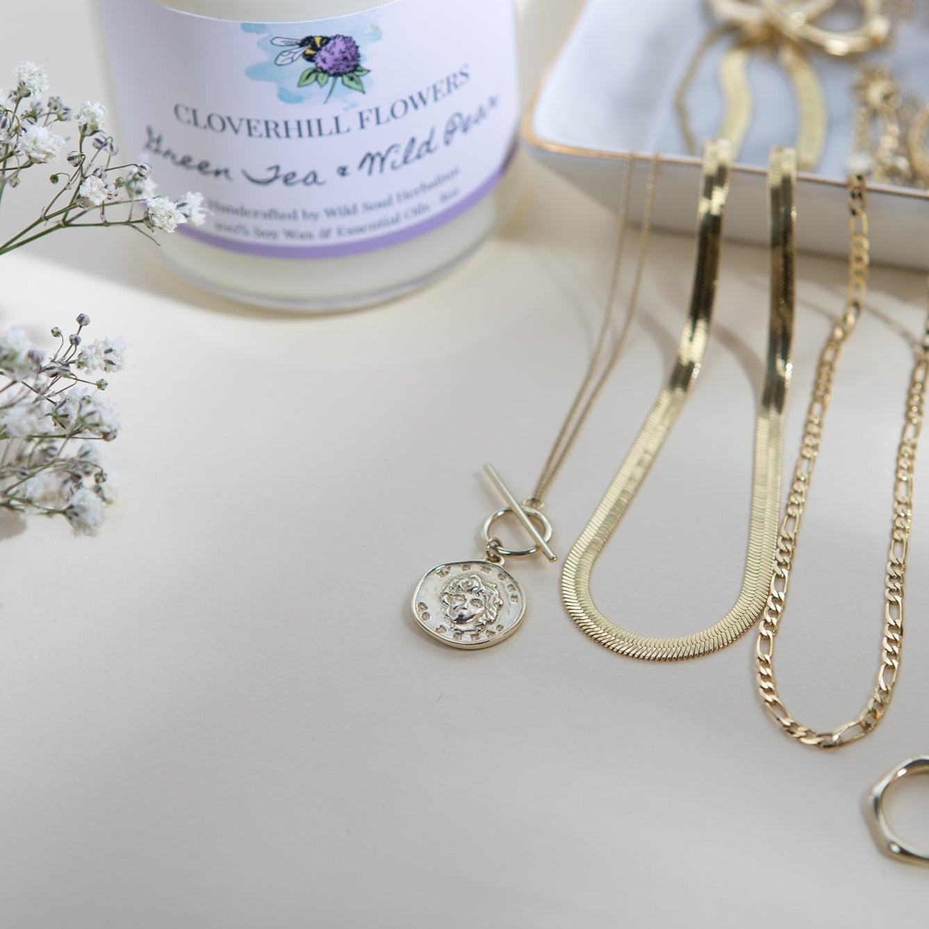 Gold Herringbone necklace with flowers and candle 