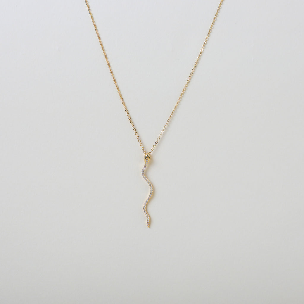 Gold necklace with a gold & crystal accented serpent