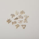 Crystal accented gold zodiac charms