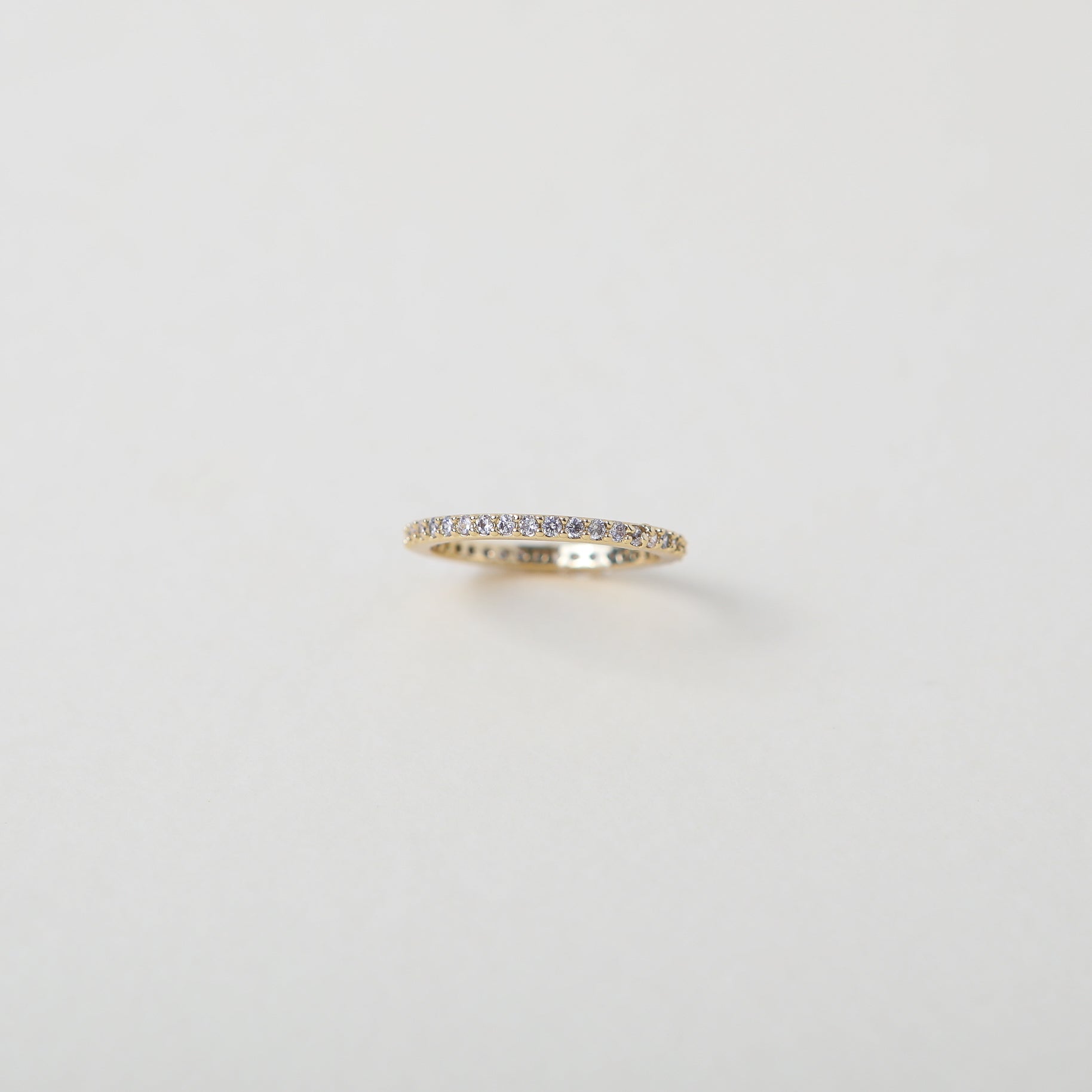 Crystal accented gold eternity ring
