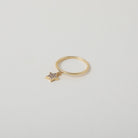 Delicate gold ring with crystal accented star charm