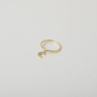 Delicate gold ring with crystal accented crescent moon charm