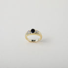 vintage heirloom style ring. Featuring the classic croissant style pattern accented with an onyx coloured crystal 